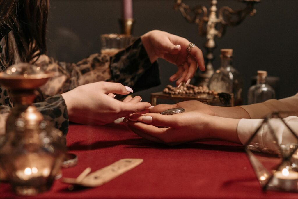 pexels-photo-7221686-7221686 A fortune teller delicately reading a client's palm in a mystic setting with enchanting ambiance.